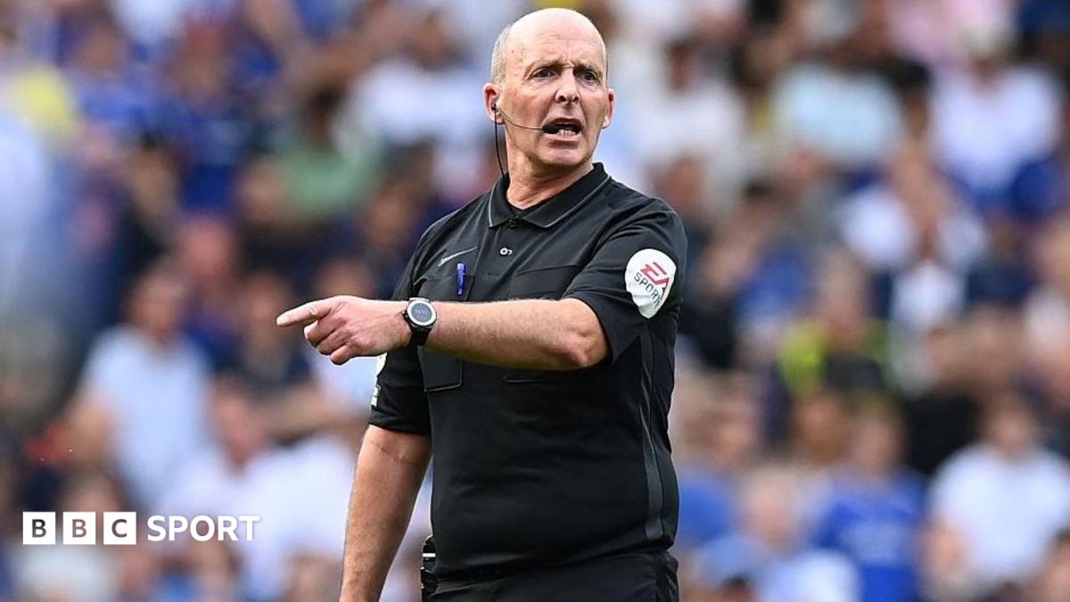English referee Mike Dean gestures during the Premier League match between Chelsea and Watford