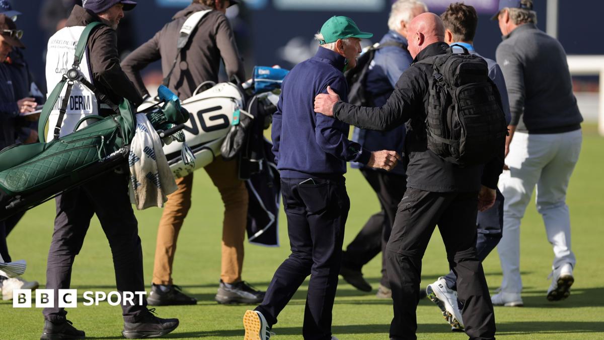 Dermot Desmond being escorted off the golf course by security
